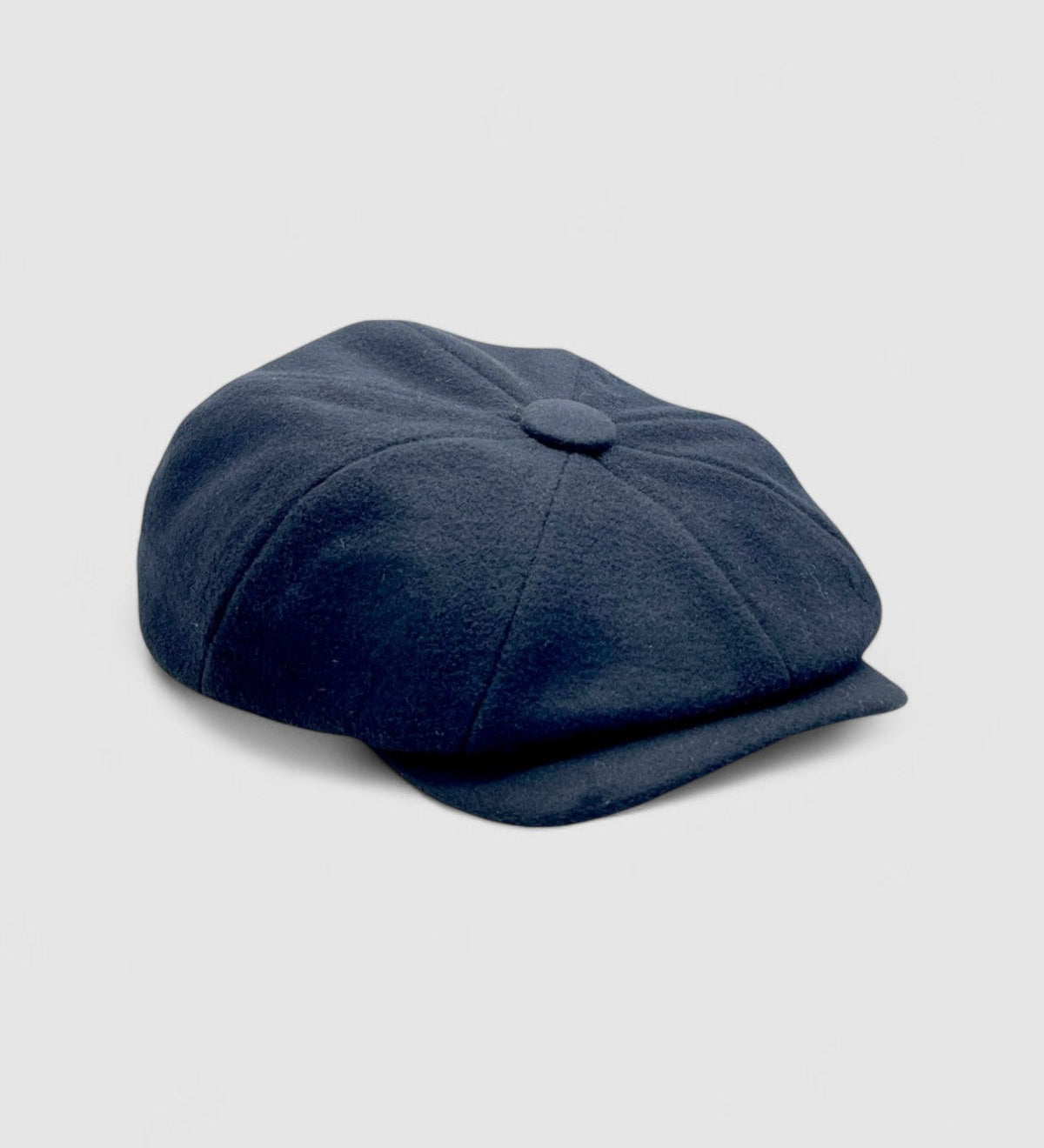 Bakerboy cap in black cashmere wool — Albert’s Ace, 8-panel with back headband, handmade by Mister Miller. Side angle.