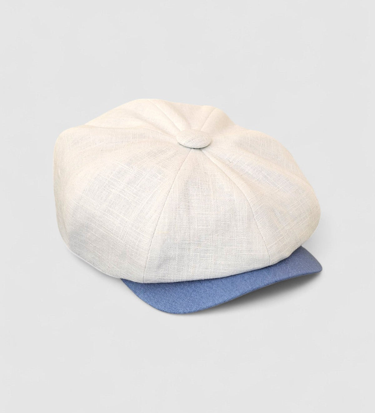 Bakerboy cap in white washed linen — Albert’s Sails, contrast blue peak detail, handmade by Mister Miller. side view.