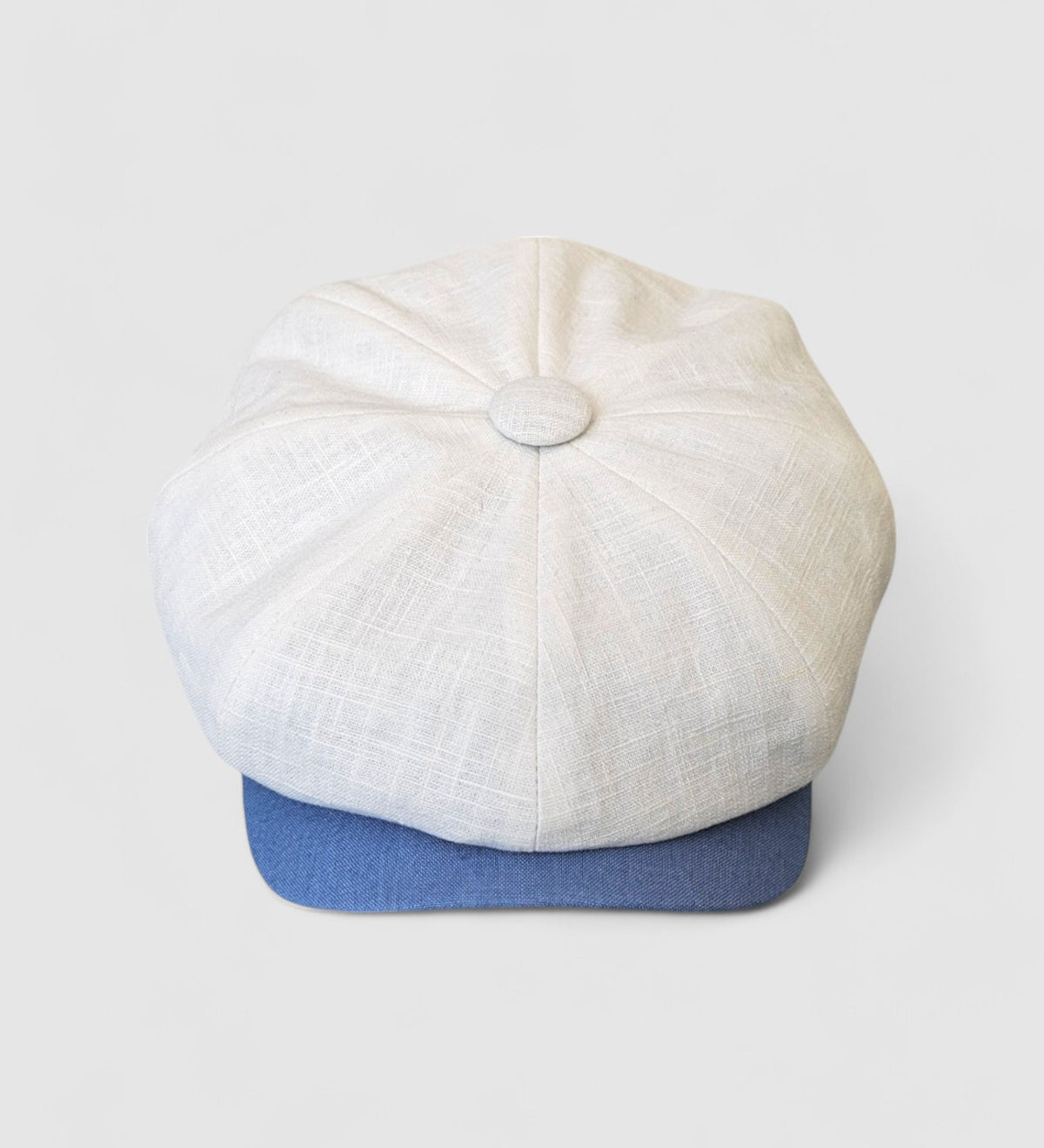 Bakerboy cap in white washed linen — Albert’s Sails, contrast blue peak detail, handmade by Mister Miller. front view.