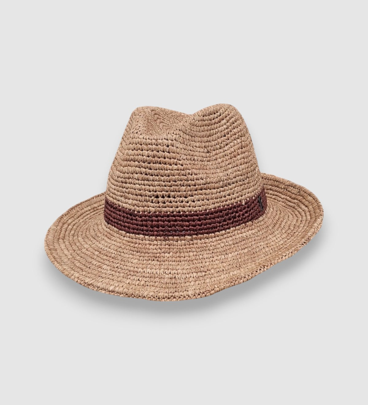 Raffia straw Fedora hat with dark brown woven band and Mister Miller keyhole detail. angle view