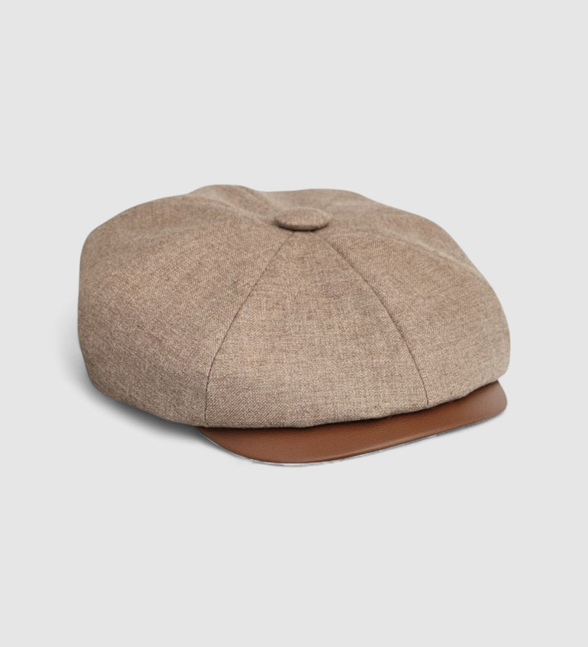 Bakerboy cap in beige cashmere wool with tan calfskin leather peak — Riley Says by Mister Miller, handmade in Britain for timeless style and quiet luxury. side view