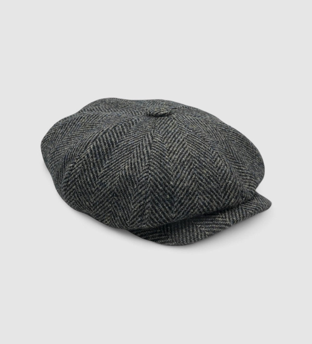 Bakerboy cap in bespoke brown, black, and navy Harris Tweed herringbone — Riley’s Gypsy by Mister Miller, handmade in Britain for the Peaky Blinders collection. side view