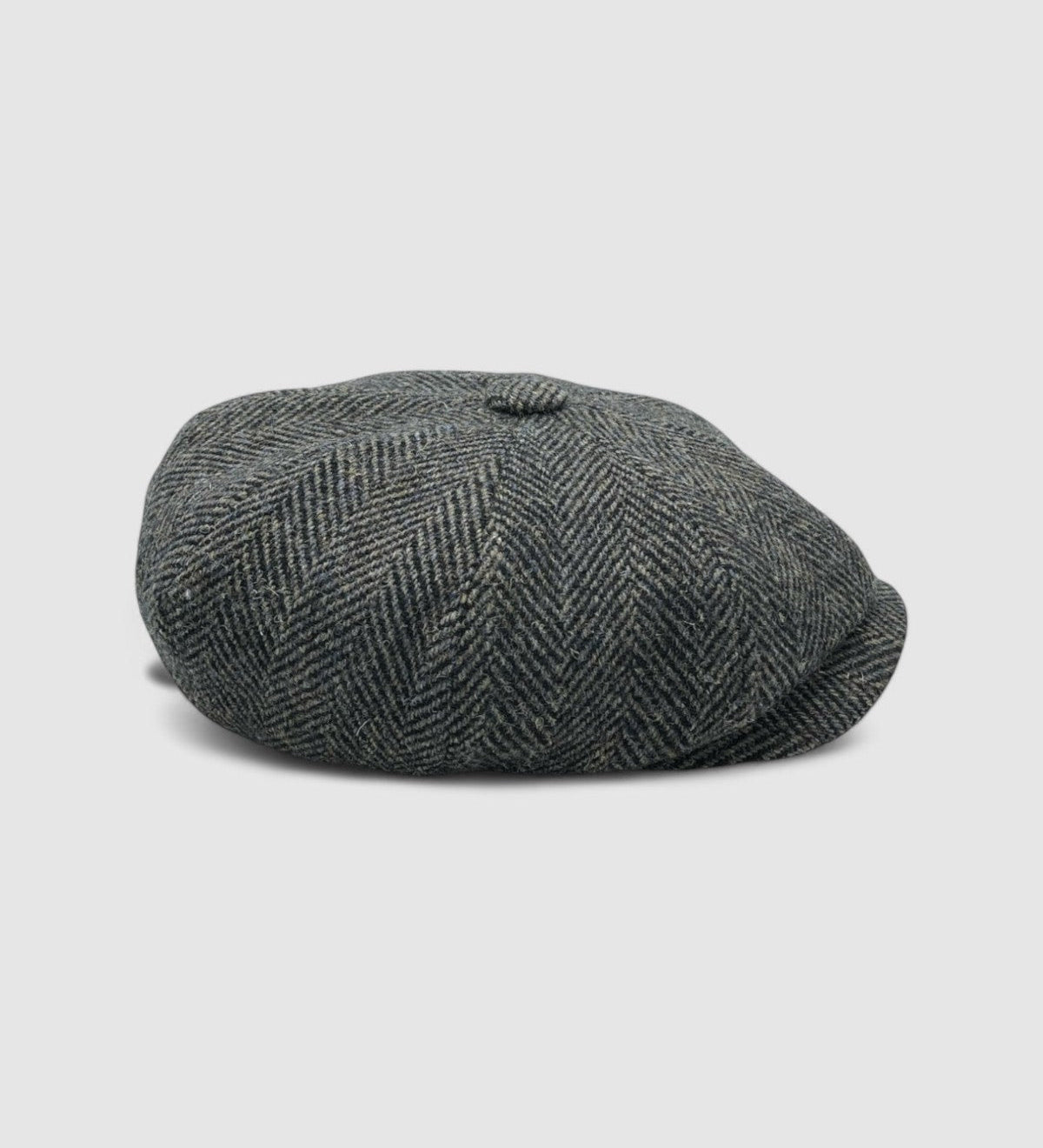 Bakerboy cap in bespoke brown, black, and navy Harris Tweed herringbone — Riley’s Gypsy by Mister Miller, handmade in Britain for the Peaky Blinders collection. Profile view