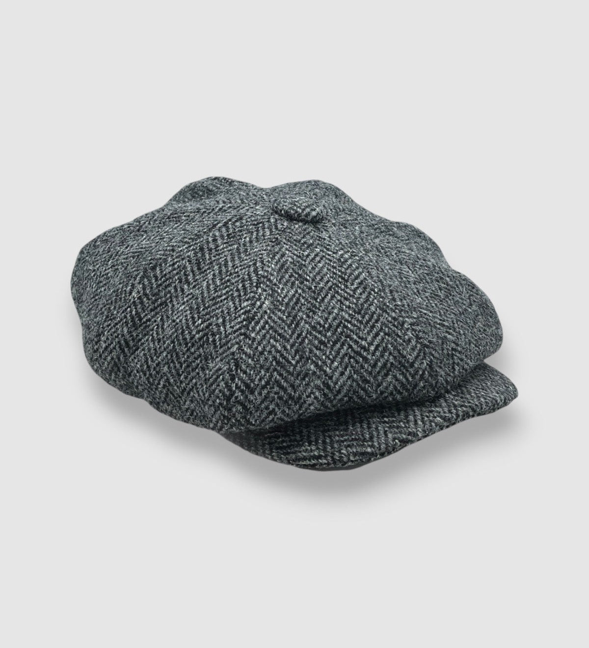 Bakerboy cap in grey herringbone Harris tweed — Riley’s Favourite by Mister Miller, a classic eight-panel hat handmade in Britain. side view