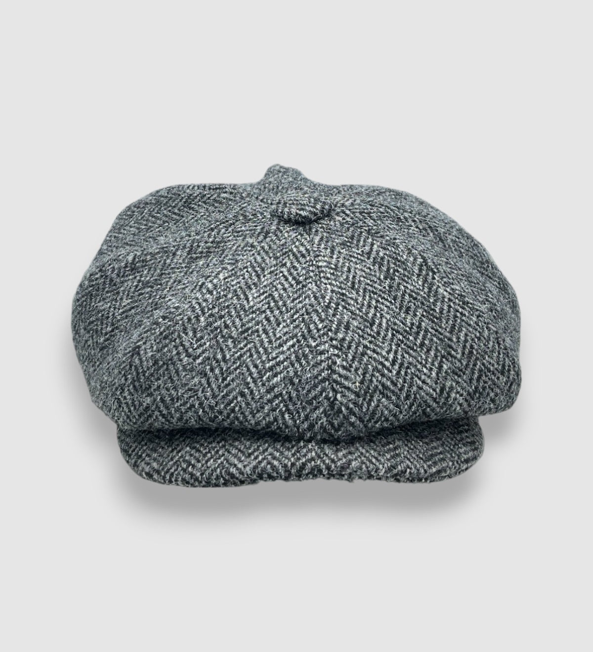 Bakerboy cap in grey herringbone Harris tweed — Riley’s Favourite by Mister Miller, a classic eight-panel hat handmade in Britain. front view