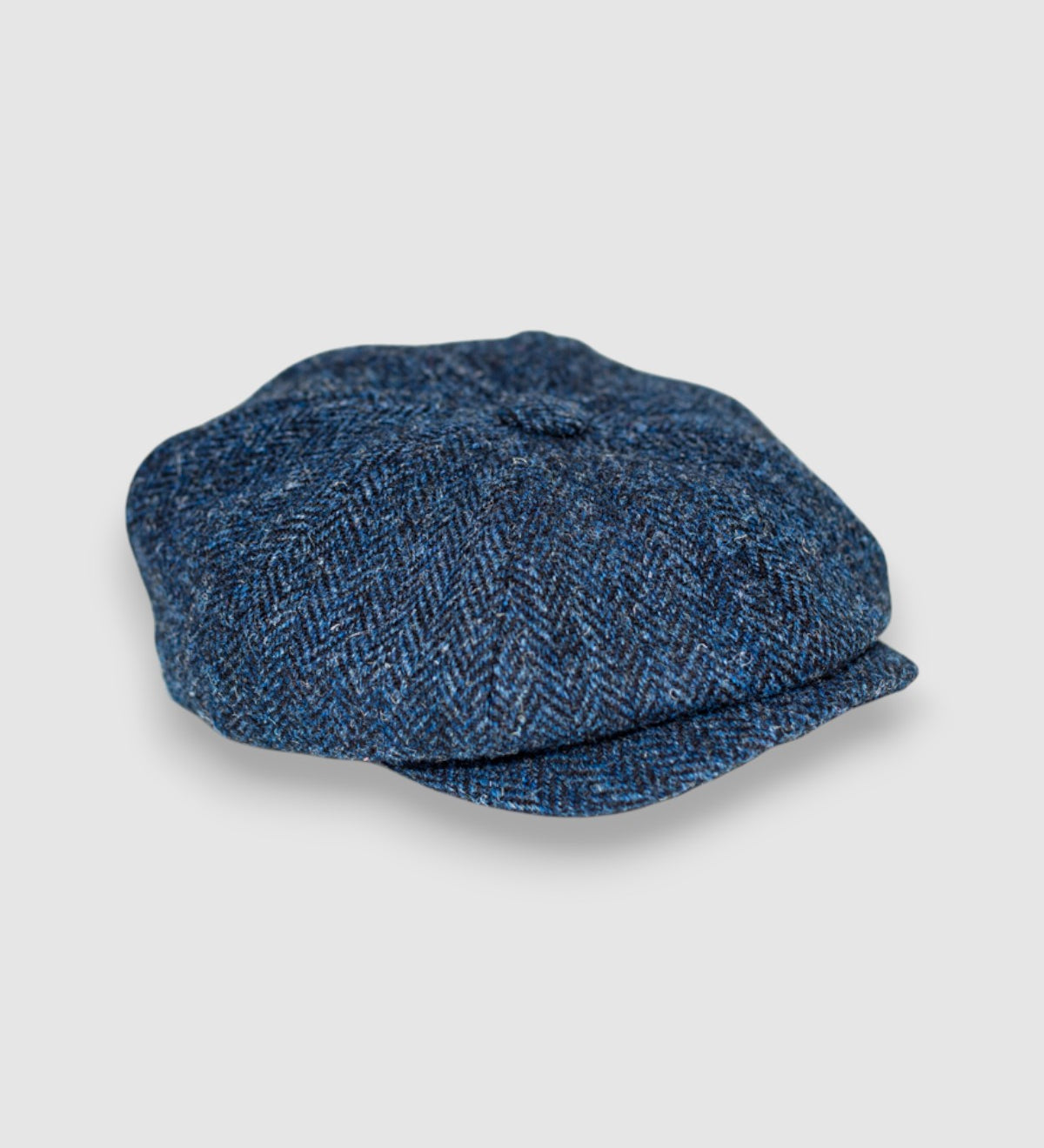 Bakerboy cap in navy and black Harris tweed — Riley’s Trail by Mister Miller, handmade in Britain. side view