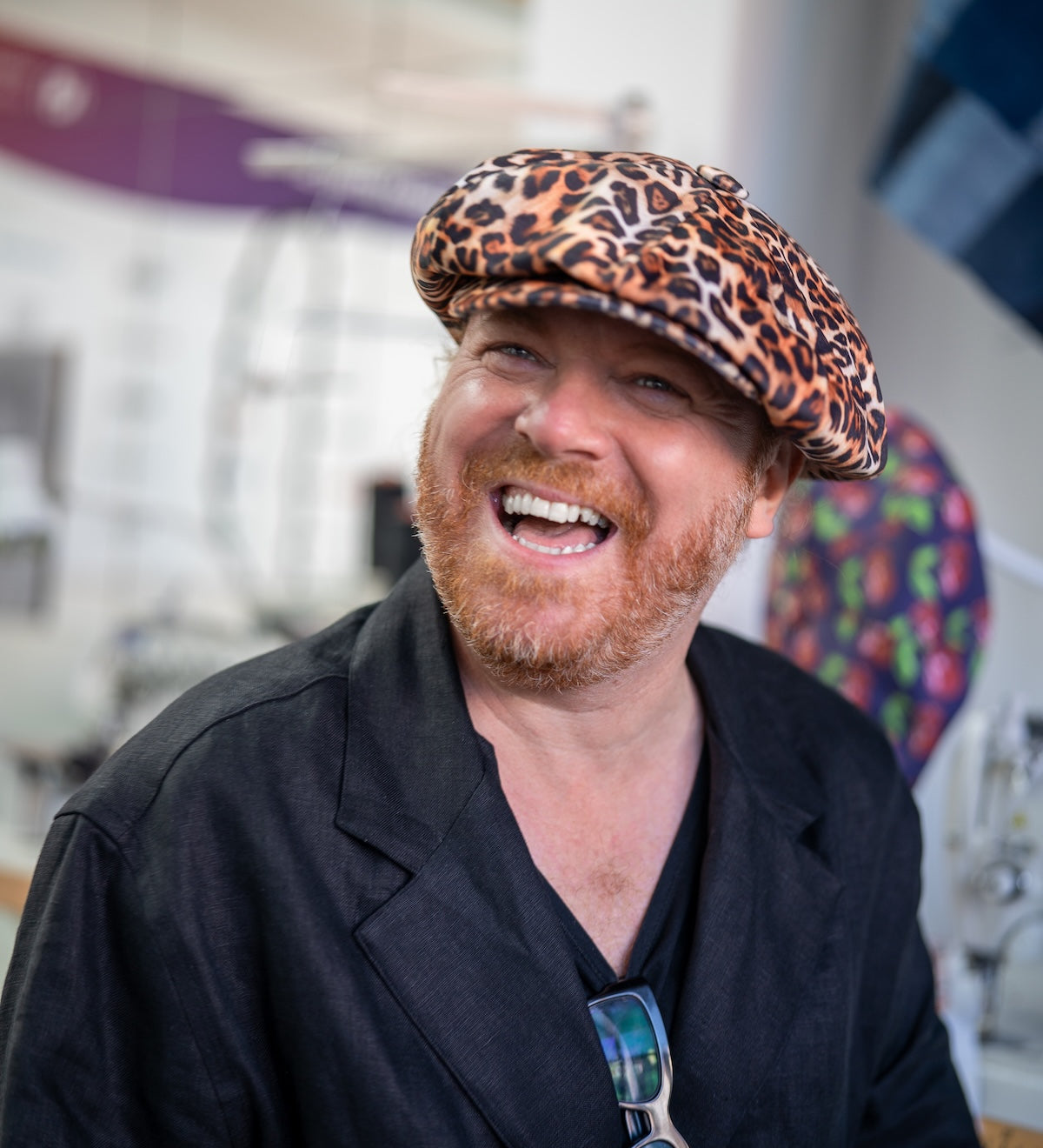 Leigh Francis wearing leopard print velvet Bakerboy hat — oversized 90s-inspired cap with curved peak and signature 70s cartoon lining from his collaboration with Mister Miller.