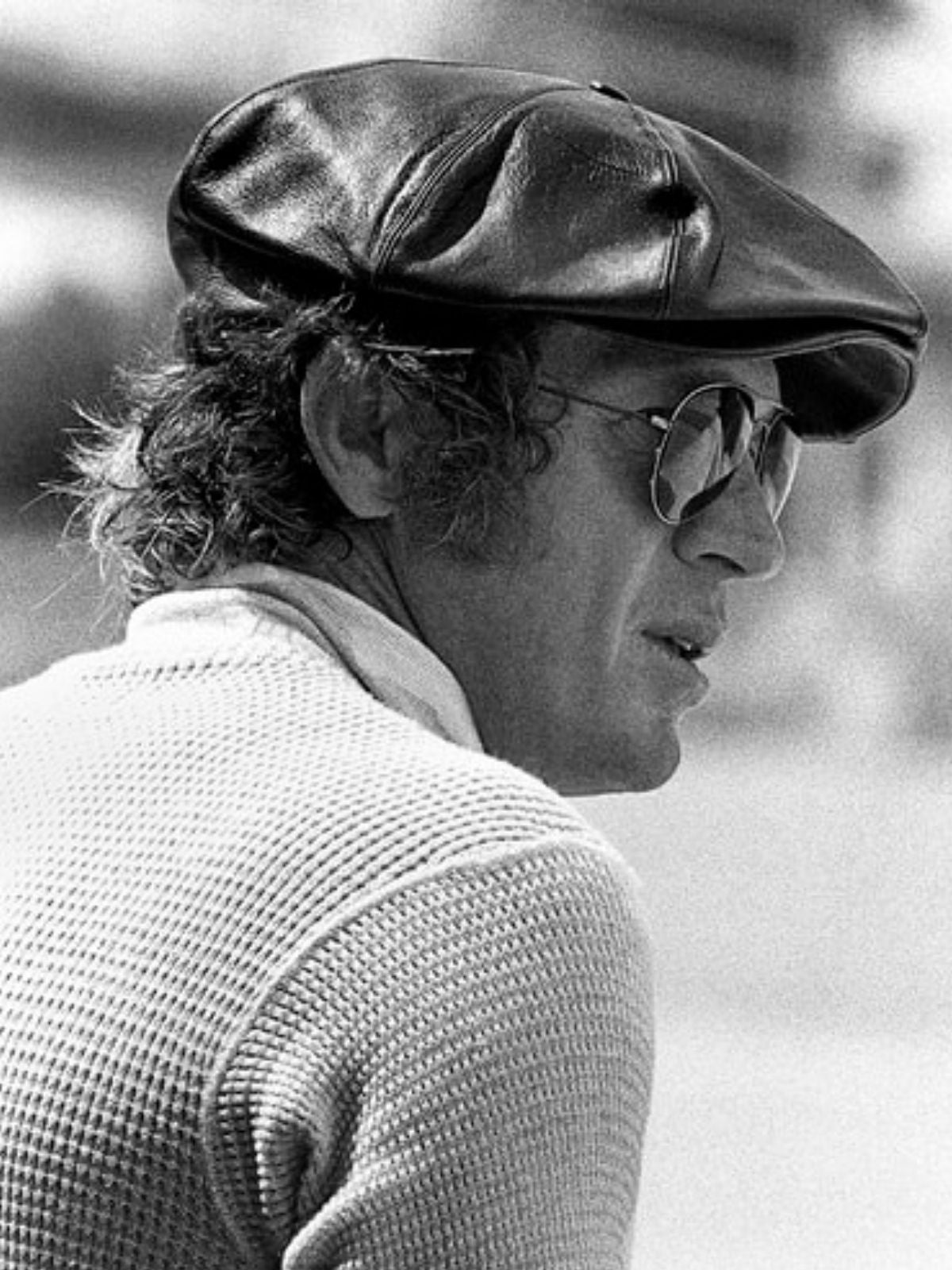 steve mcqueen wearing a black leather bakerboy cap