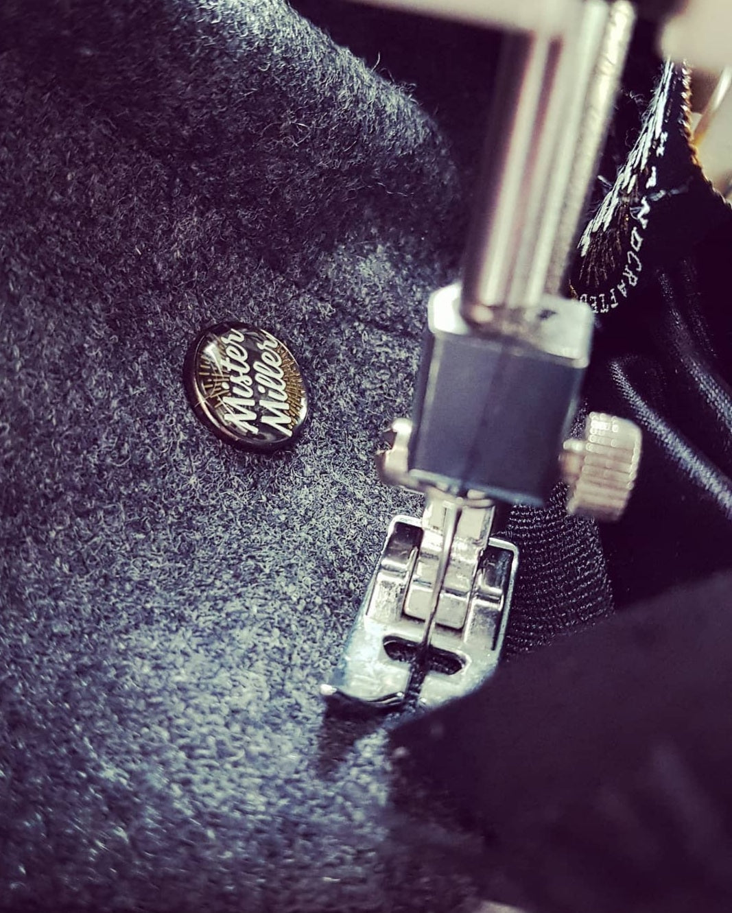 British hatmaking workshop selecting Harris Tweed and luxury wool fabrics for handmade hats