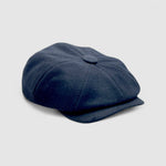 Bakerboy cap in black cashmere wool — Albert’s Ace, 8-panel with back headband, handmade by Mister Miller. Side angle.
