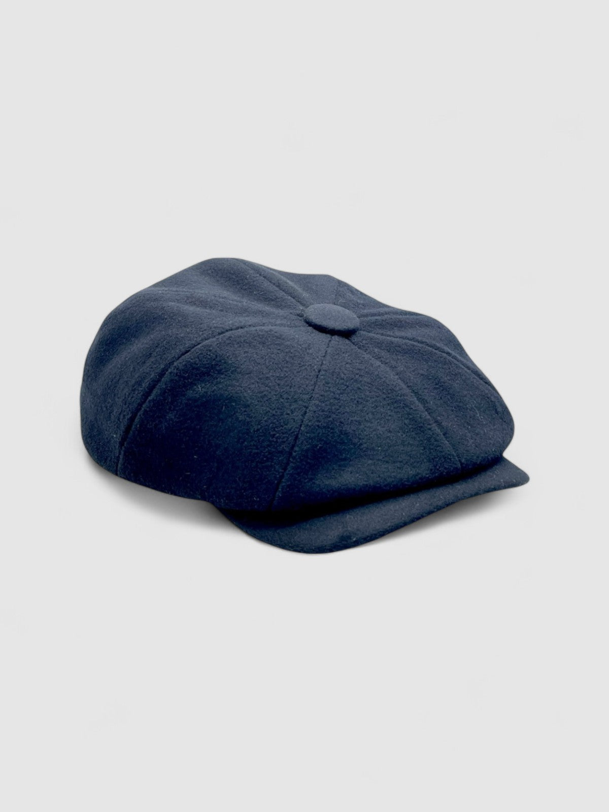 Bakerboy cap in black cashmere wool — Albert’s Ace, 8-panel with back headband, handmade by Mister Miller. Side angle.