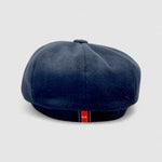 Bakerboy cap in black cashmere wool — Albert’s Ace, 8-panel with back headband, handmade by Mister Miller. Rear view.