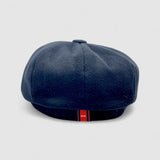 Bakerboy cap in black cashmere wool — Albert’s Ace, 8-panel with back headband, handmade by Mister Miller. Rear view.
