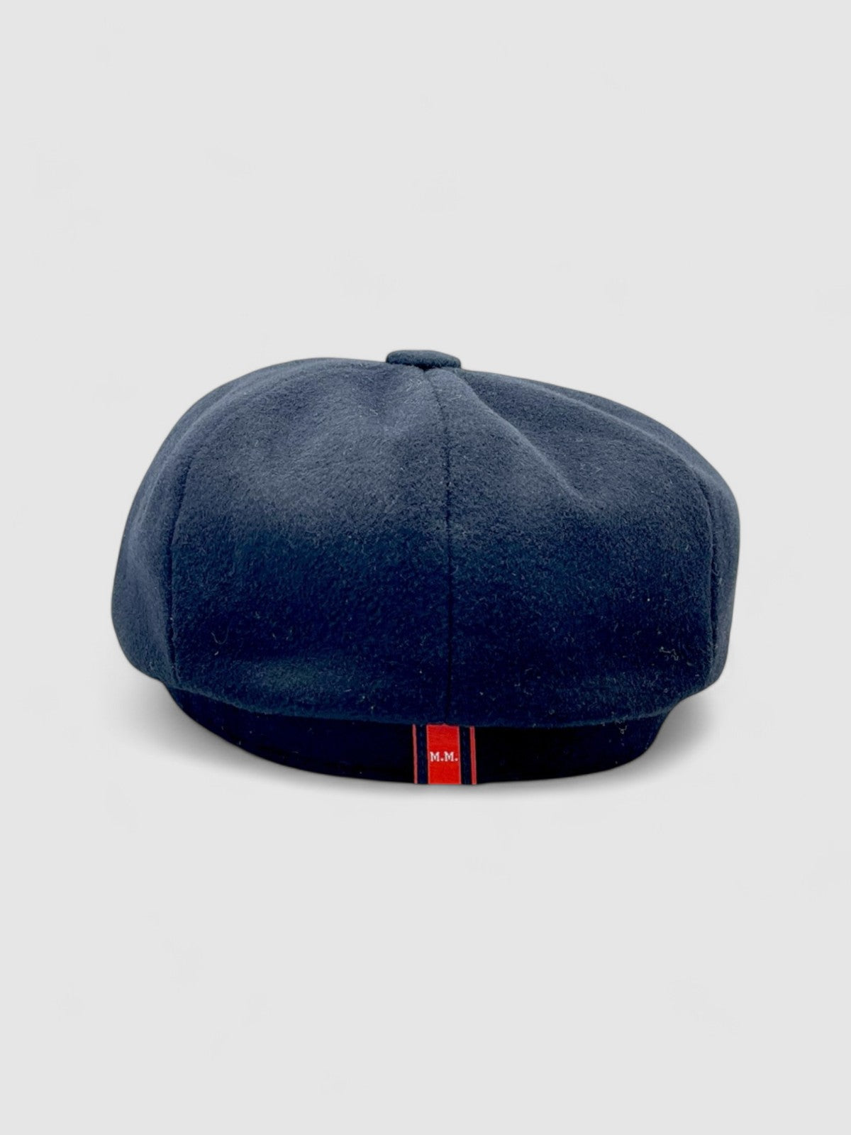 Bakerboy cap in black cashmere wool — Albert’s Ace, 8-panel with back headband, handmade by Mister Miller. Rear view.