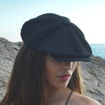 Bakerboy cap in black washed linen — Albert’s Nights, versatile spring/summer style, handmade by Mister Miller. worn by a woman. 