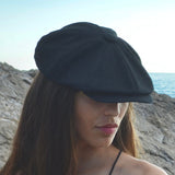 Bakerboy cap in black washed linen — Albert’s Nights, versatile spring/summer style, handmade by Mister Miller. worn by a woman. 