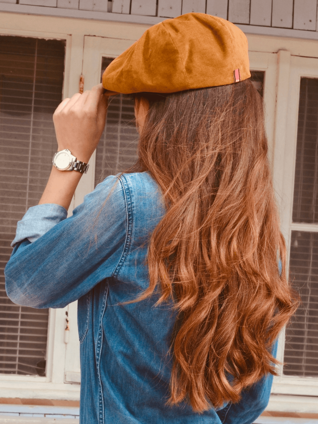 WOMAN wearing tan corduroy newsboy cap 