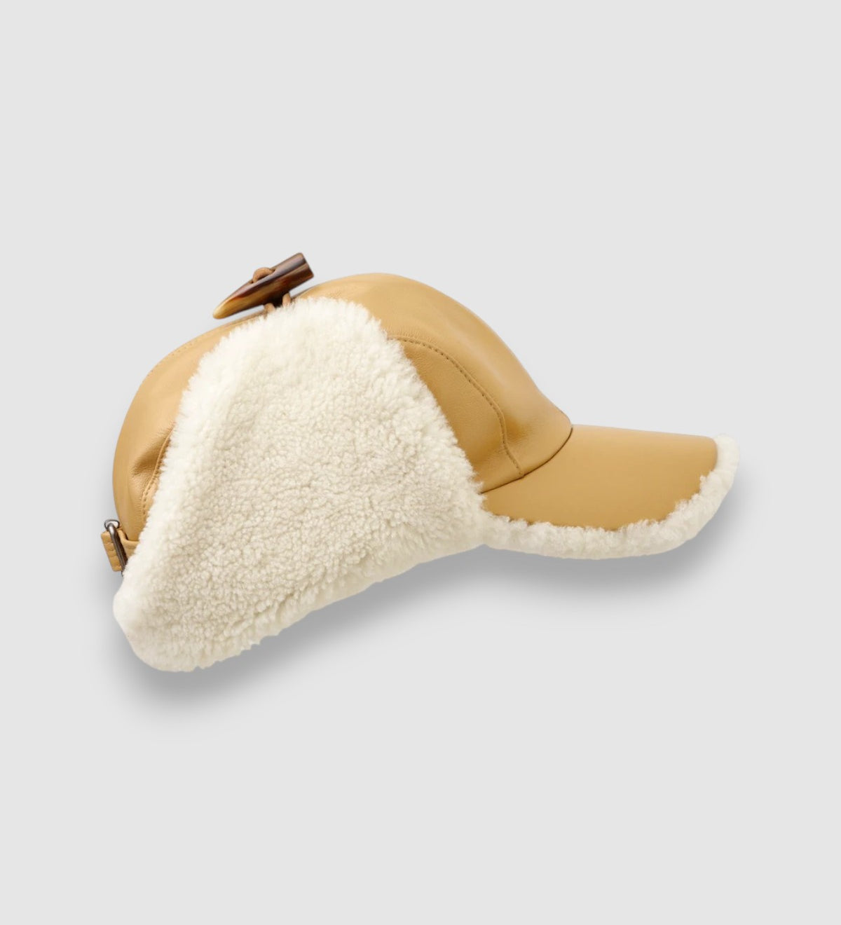 Cream shearling driving cap with tan leather exterior – Bailey Merino sheepskin hat handmade in Britain. profile view.