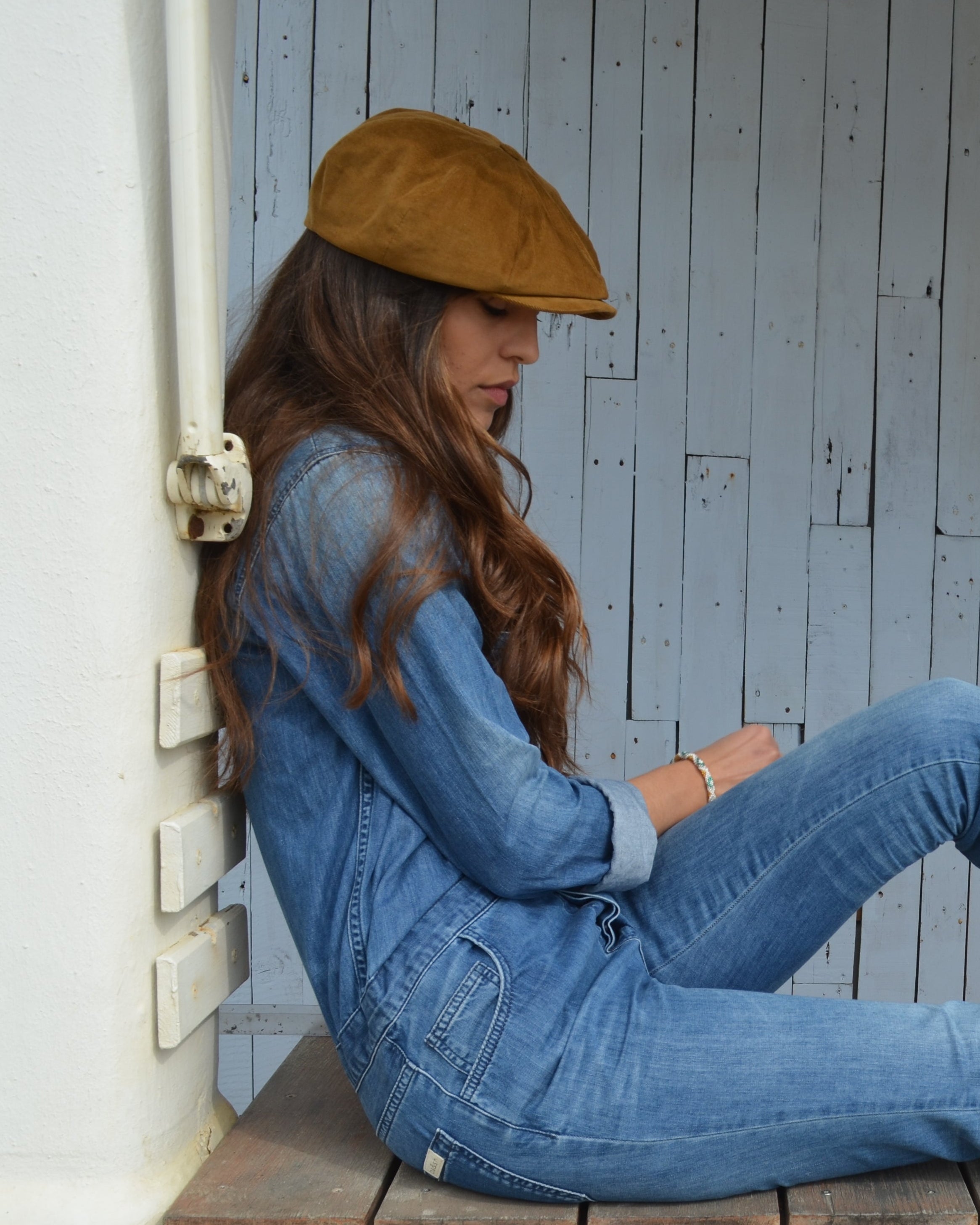 woman in denim with a tan corduroy newsboy cap from mister miller