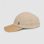 Camel cashmere herringbone baseball cap with tan leather peak by Mister Miller. profile view