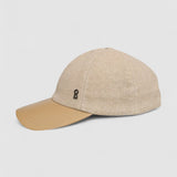 Camel cashmere herringbone baseball cap with tan leather peak by Mister Miller. profile view