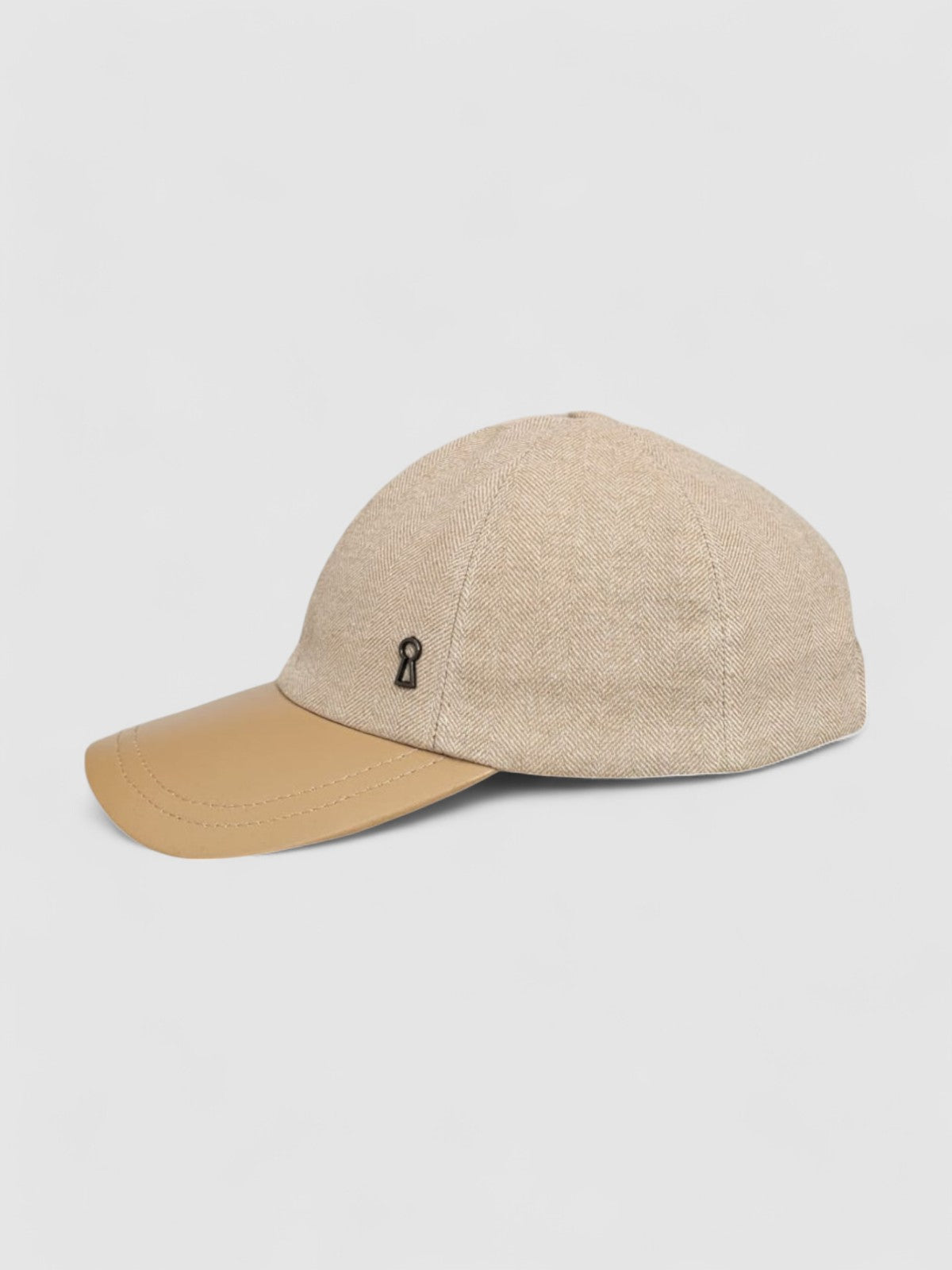 Camel cashmere herringbone baseball cap with tan leather peak by Mister Miller. profile view