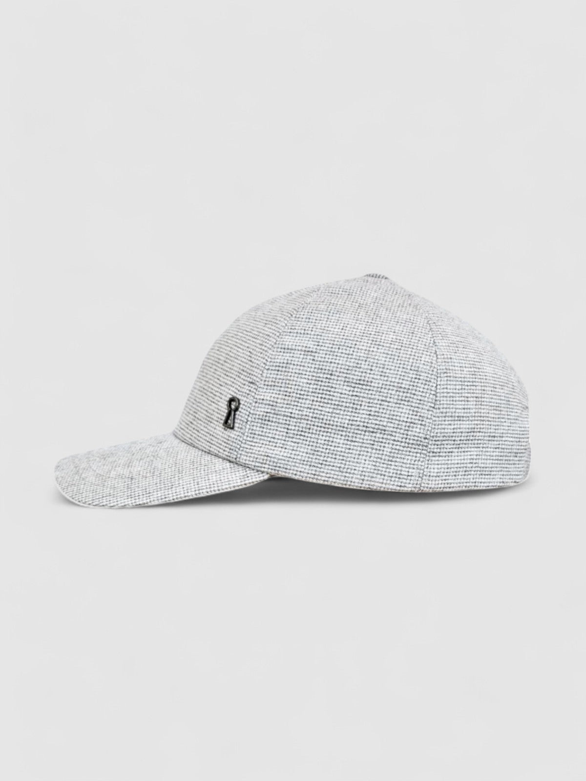Grey textured baseball cap with adjustable fit, handmade by Mister Miller. profile view