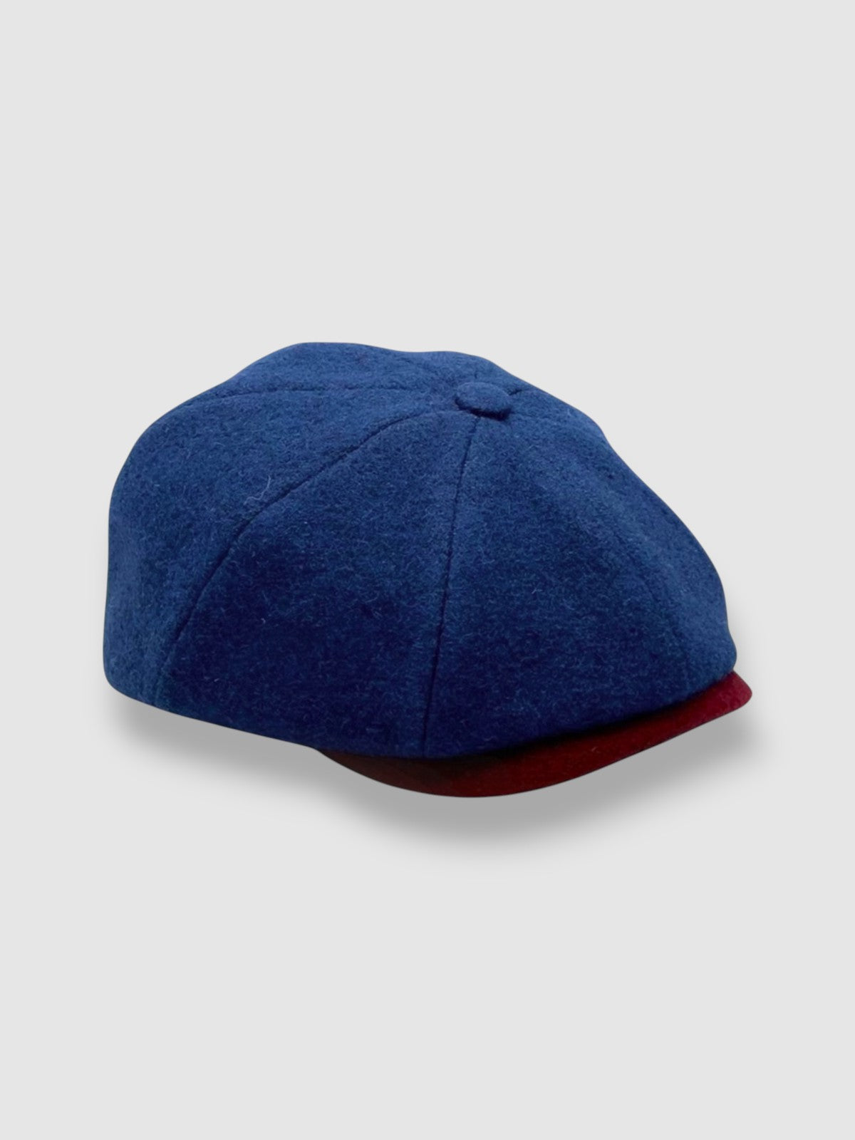 Newsboy cap in teal Melton wool with red and grey contrast peak – Jack’s Steal by Mister Miller. side view