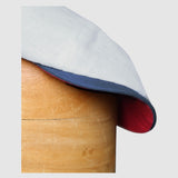detail shot of the peak of a Slim-cut Newsboy cap in pale blue, red and white linen – Jack’s Sails handmade by Mister Miller