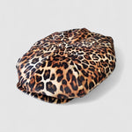 Leopard print velvet Bakerboy cap — oversized silhouette from the Leigh Francis x Mister Miller collection, featuring curved peak, bold 90s style, and signature 70s swirl lining. Side view