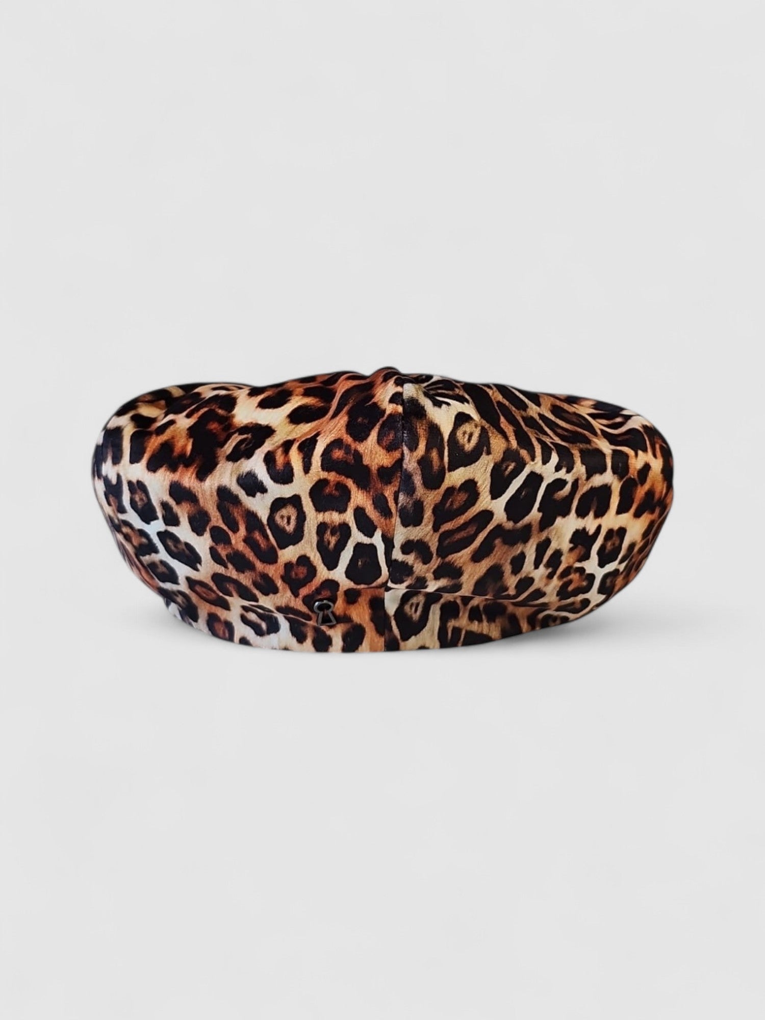 Leopard print velvet Bakerboy cap — oversized silhouette from the Leigh Francis x Mister Miller collection, featuring curved peak, bold 90s style, and signature 70s swirl lining. Rear view.