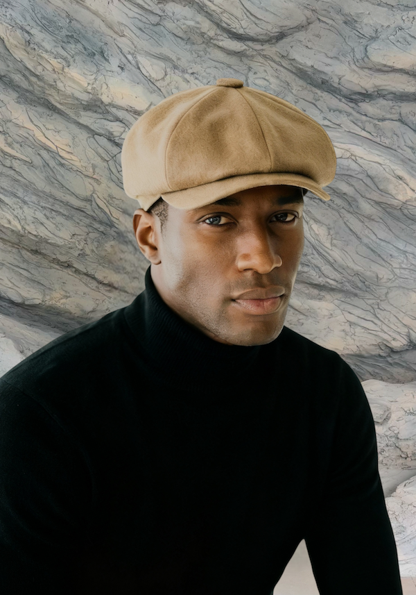MAN IN BEIGE BAKERBOY CAP