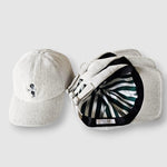Two baseball caps, one plain and one with a pattern, on a light gray background.