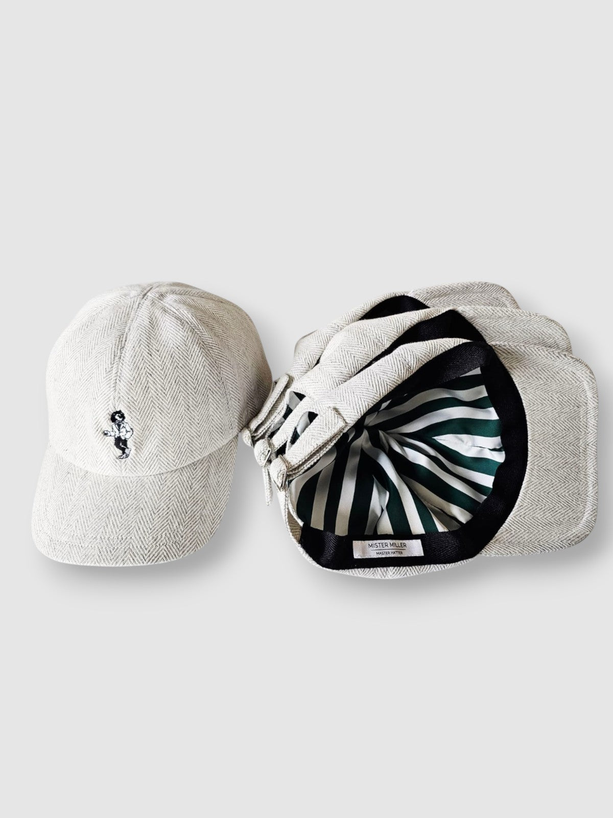Two baseball caps, one plain and one with a pattern, on a light gray background.