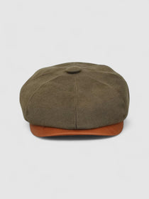 Bakerboy cap in racing green water-repellent cotton moleskin with tan calfskin leather peak — Riley’s Gears by Mister Miller, handmade in Britain for refined weatherproof style. Front view