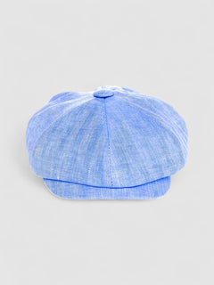 Bakerboy cap in light blue Irish linen herringbone — Riley Skies by Mister Miller, a breathable summer hat handmade in Britain. front view