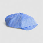 Bakerboy cap in light blue Irish linen herringbone — Riley Skies by Mister Miller, a breathable summer hat handmade in Britain. Profile view
