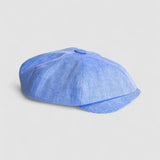 Bakerboy cap in light blue Irish linen herringbone — Riley Skies by Mister Miller, a breathable summer hat handmade in Britain. Profile view