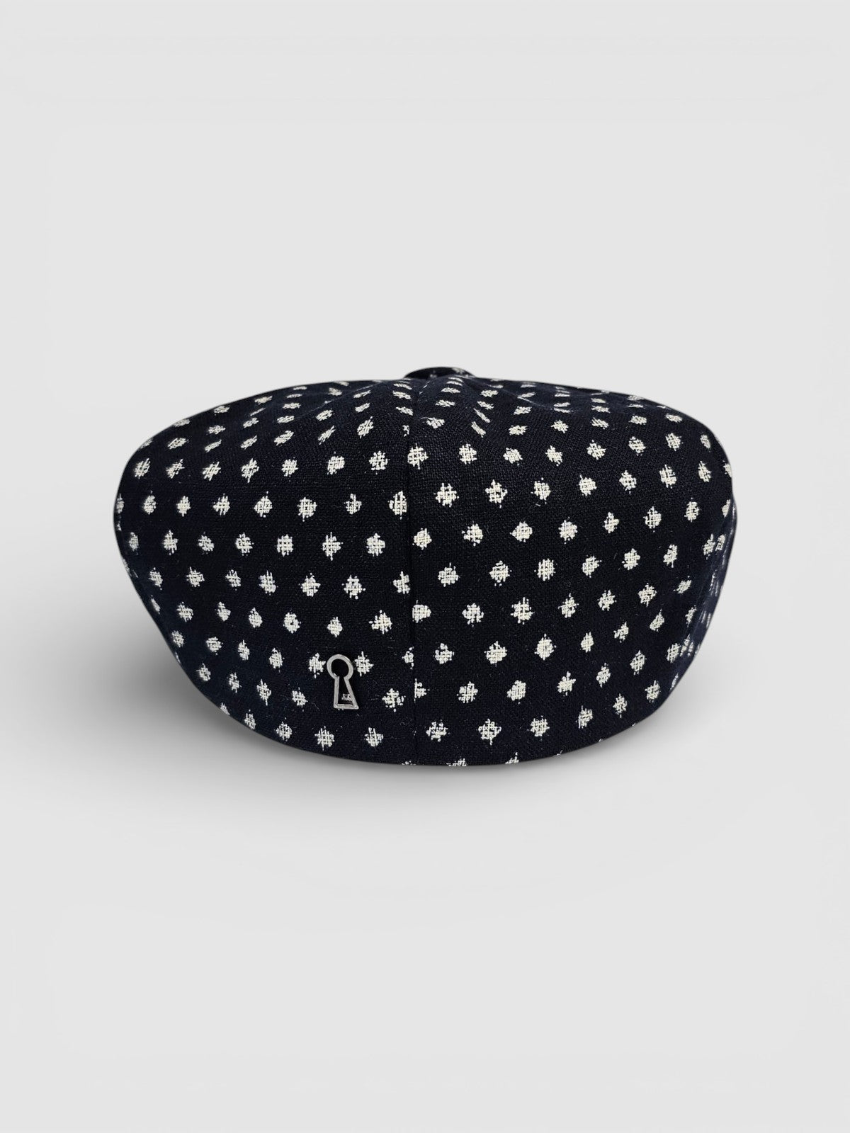 Navy Bakerboy cap with white polka dots rear view