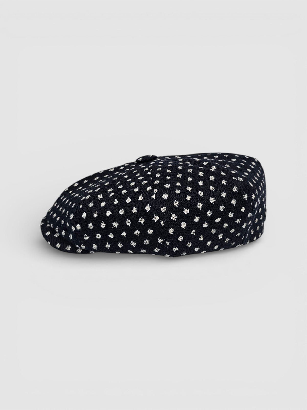 Navy Bakerboy cap with white polka dots profile view