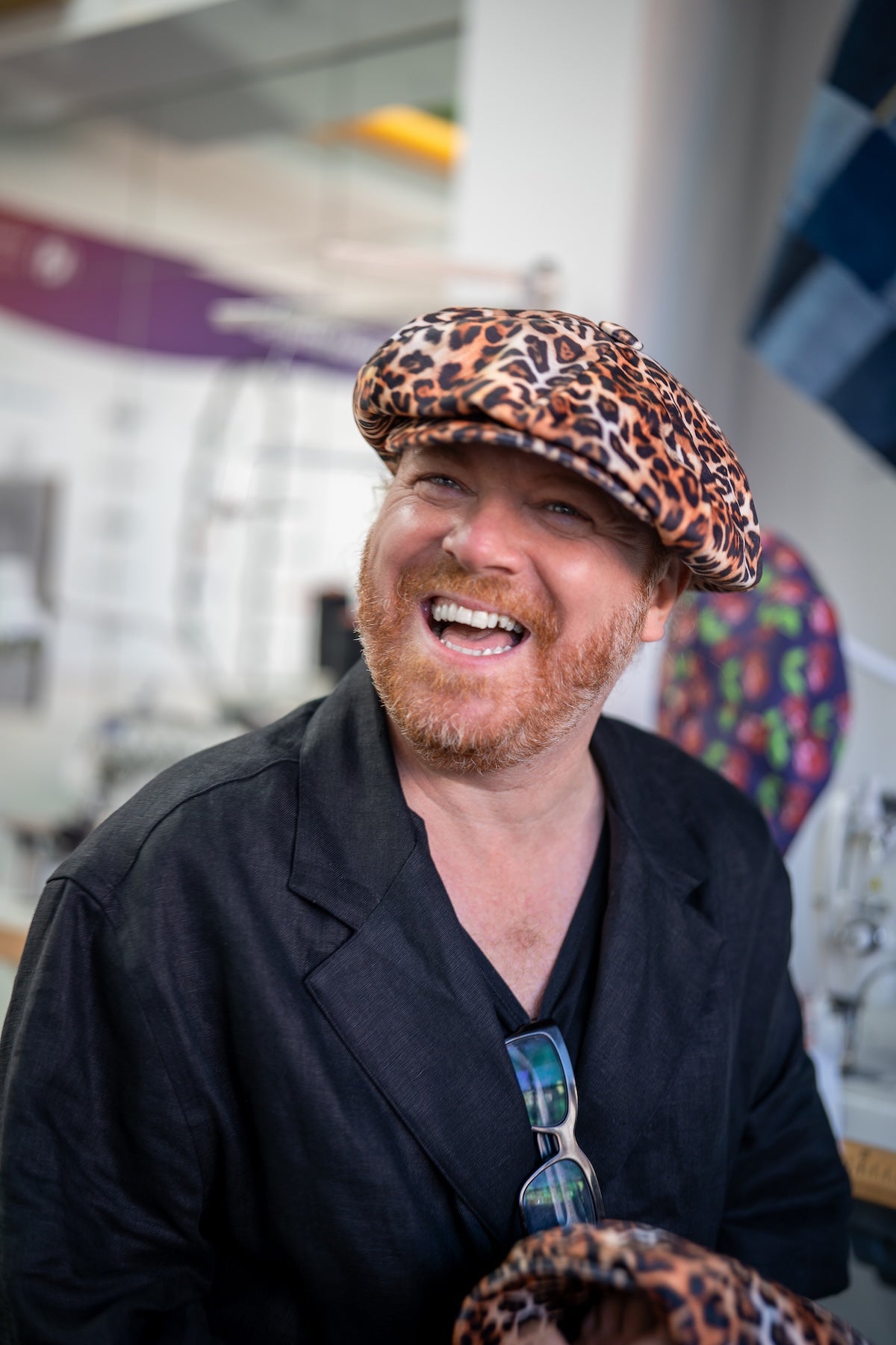 Leigh Francis wearing leopard print velvet Bakerboy hat — oversized 90s-inspired cap with curved peak and signature 70s cartoon lining from his collaboration with Mister Miller.