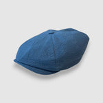 Blue newsboy cap in blue seersucker angle view