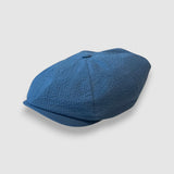 Blue newsboy cap in blue seersucker angle view