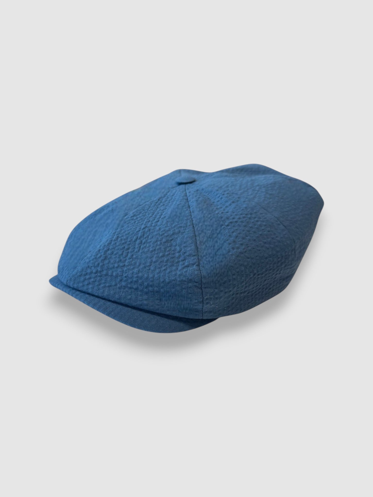 Blue newsboy cap in blue seersucker angle view